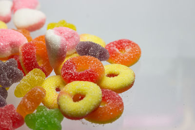 Close-up of multi colored candies against white background