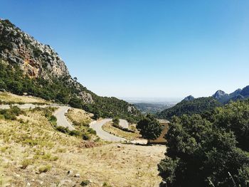 Scenic view of mountains against clear blue sky