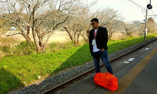 Full length of young man on railroad track