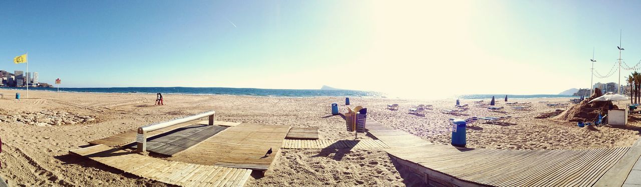 beach, sea, water, sand, horizon over water, clear sky, sunlight, shore, vacations, scenics, tranquil scene, relaxation, beach umbrella, tranquility, sunny, chair, sky, lounge chair, parasol, incidental people