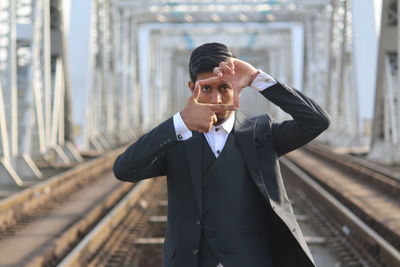 Man standing on railroad track