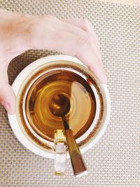 Directly above shot of person holding tea cup