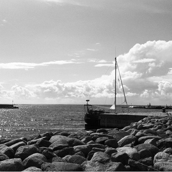 sea, water, sky, transportation, nautical vessel, horizon over water, boat, mode of transport, tranquility, rock - object, tranquil scene, cloud - sky, scenics, nature, cloud, beauty in nature, pier, shore, day, moored