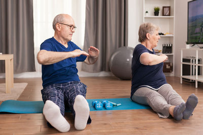 Senior couple exercising at home