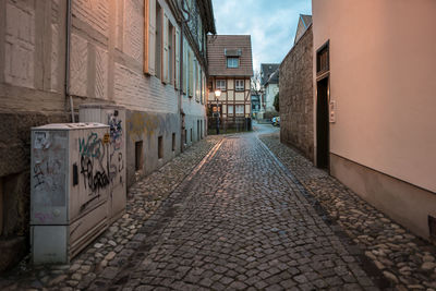 Empty alley amidst buildings in city