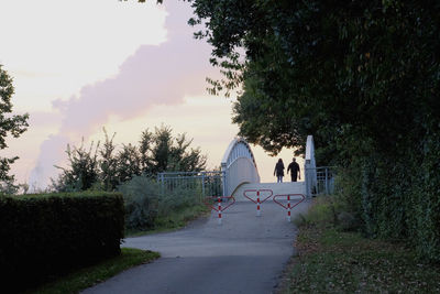 People walking on road against sky