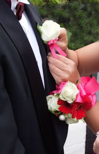 Midsection of woman holding rose bouquet