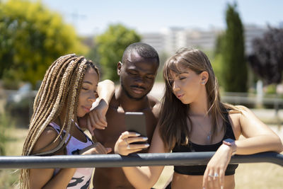Young people in the park using their smartphone