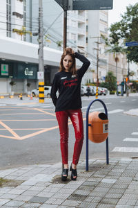 Portrait of young woman standing on road