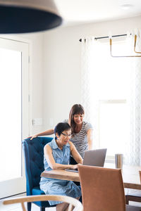 Young woman using laptop at home