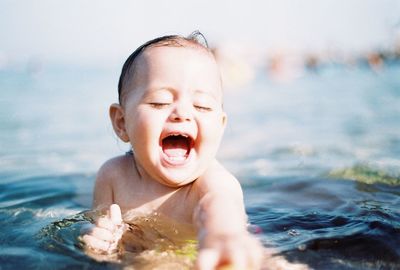 Portrait of young woman in water