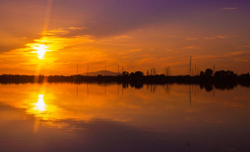Scenic view of lake against sky during sunset