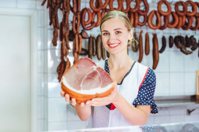 Portrait of a smiling young woman holding ice cream