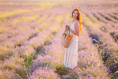 Close-up of woman standing on lavender field