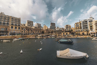 Boats moored at harbor