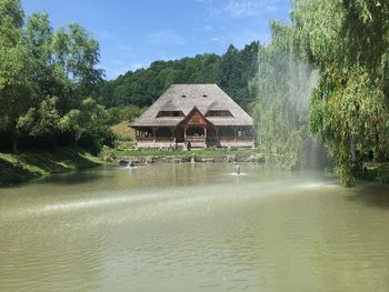 Gazebo by lake against sky