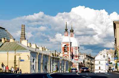 Panoramic view of city street and buildings against sky