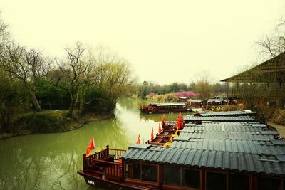 Boats in river with buildings in background