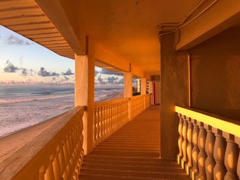 Empty walkway leading towards sea