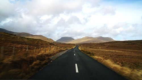 Road amidst landscape against sky