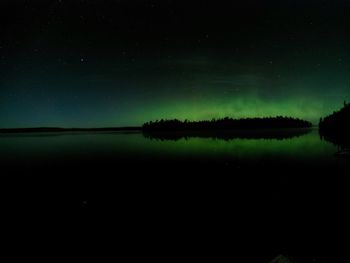 Scenic view of lake against sky at night