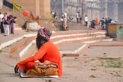 People sitting on street in city