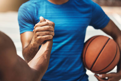 Midsection of man playing basketball
