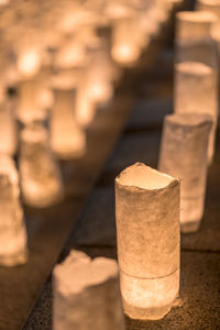 Handmade japanese washi paper lanterns aligned 
 illuminating the zojoji temple.