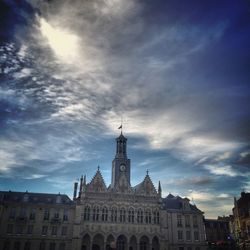 Low angle view of building against cloudy sky