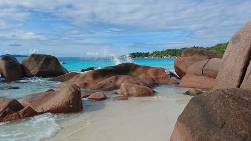 Rocks on beach against sky