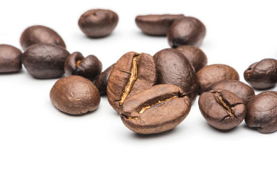 Close-up of coffee beans against white background