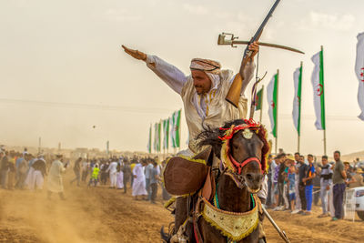 Rear view of man horse on field