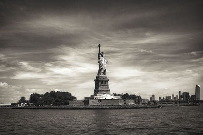 Statue of liberty against sky in city
