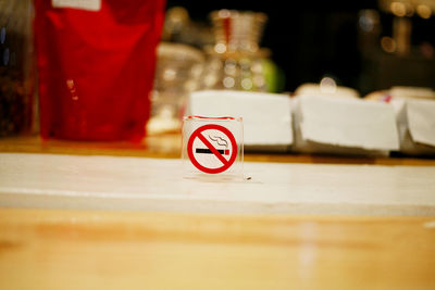 Close-up of smoking sign on table