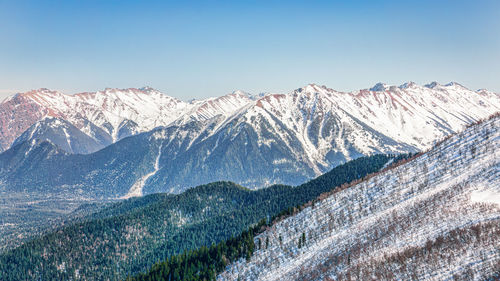 Scenic view of snowcapped mountains against clear sky