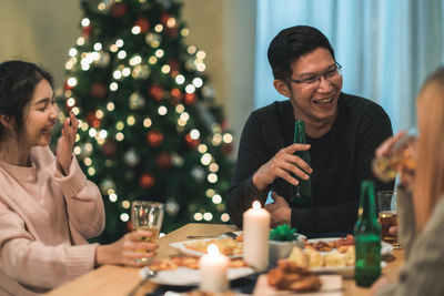 Man and woman sitting on table