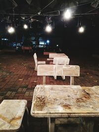 Empty chairs and table at night