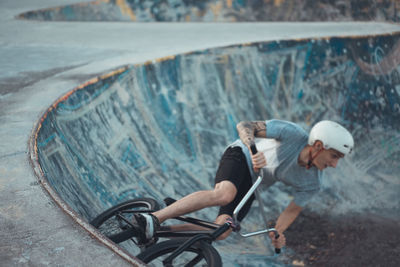 Man cycling on sports ramp