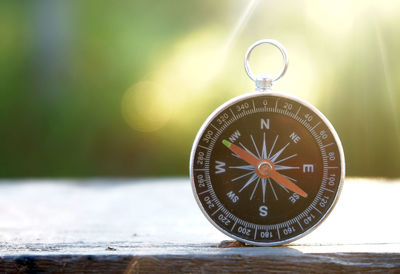 Close-up of information sign compass on table