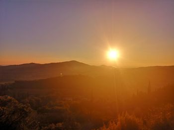 Scenic view of silhouette mountains against sky during sunset