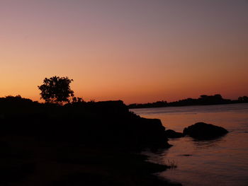 Scenic view of sea against clear sky during sunset