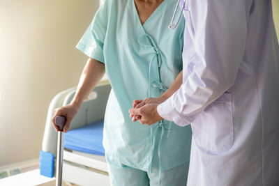 Midsection of woman standing in front of two people