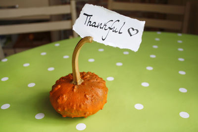 Thanksgiving day, a pumpkin and a note on paper