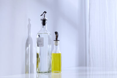 Close-up of glass bottle on table at home