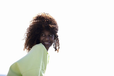 Portrait of young woman against white background