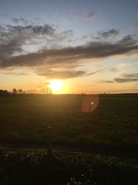 Scenic view of field against sky during sunset