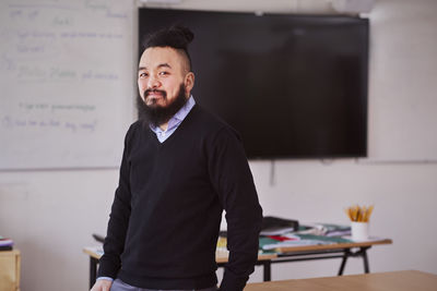 Smiling teacher looking at camera