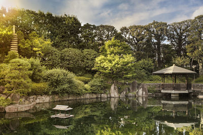 Sunset on hexagonal gazebo ukimido in the central pond of mejiro garden.