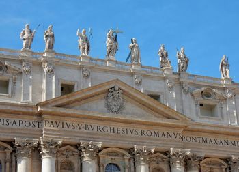 Low angle view of statues against sky