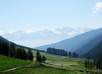 Scenic view of field and mountains against sky